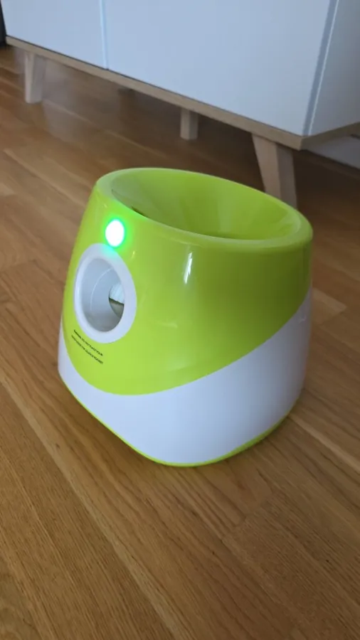 The launcher with its indicator light on, in a living room