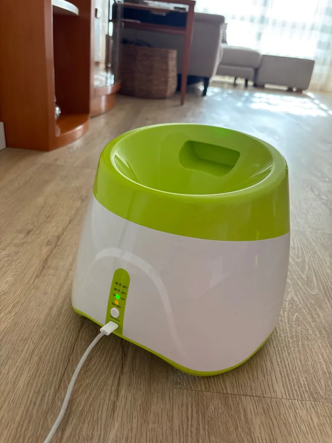 The launcher on a wooden floor, charging cable plugged in