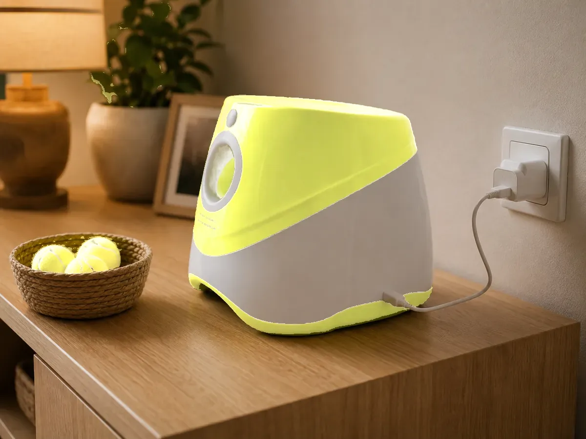 The launcher on a pale wooden console, its USB-C cable plugged in, three balls in a basket